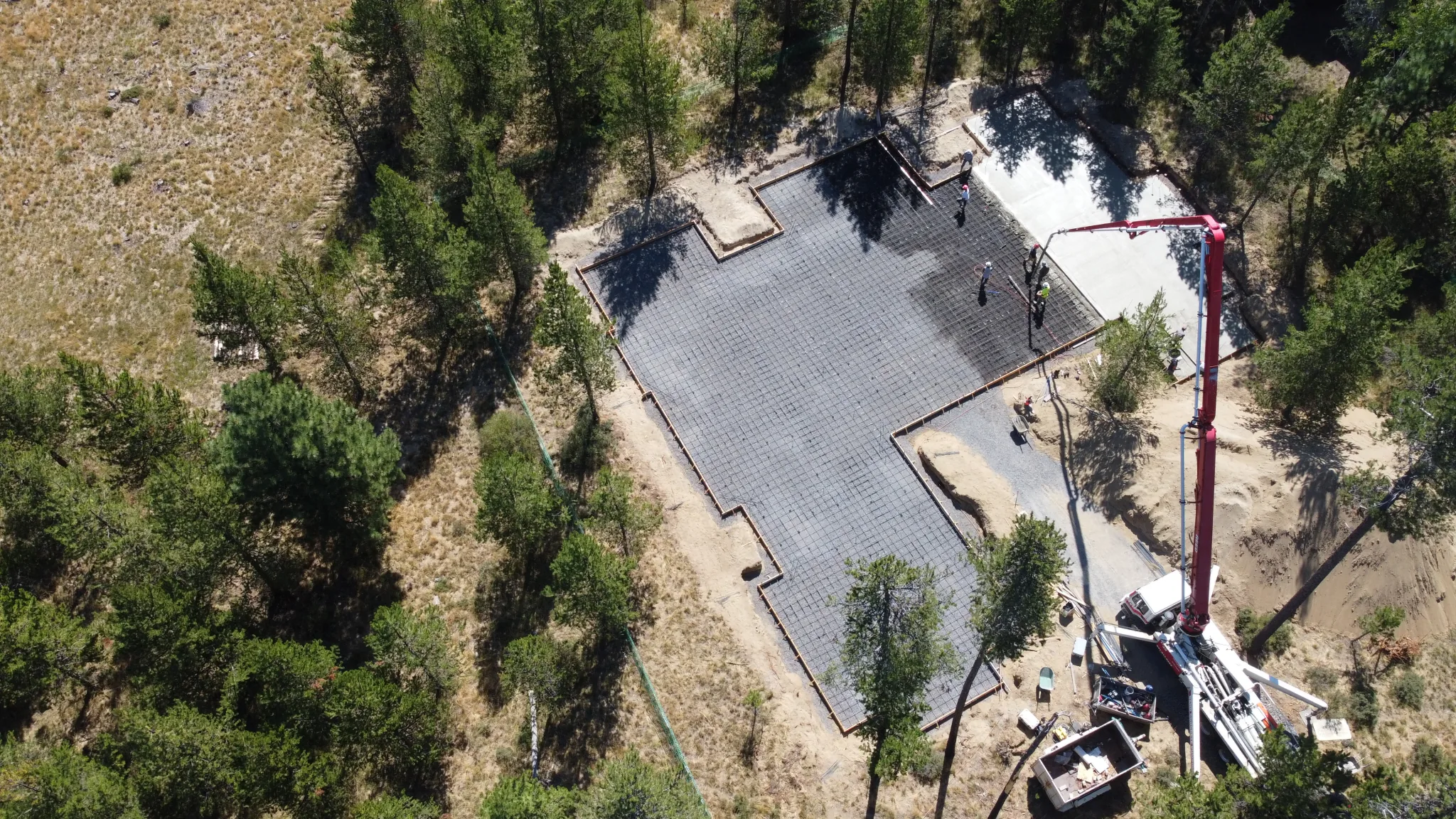 Aerial view of a residential foundation pour with boom pump