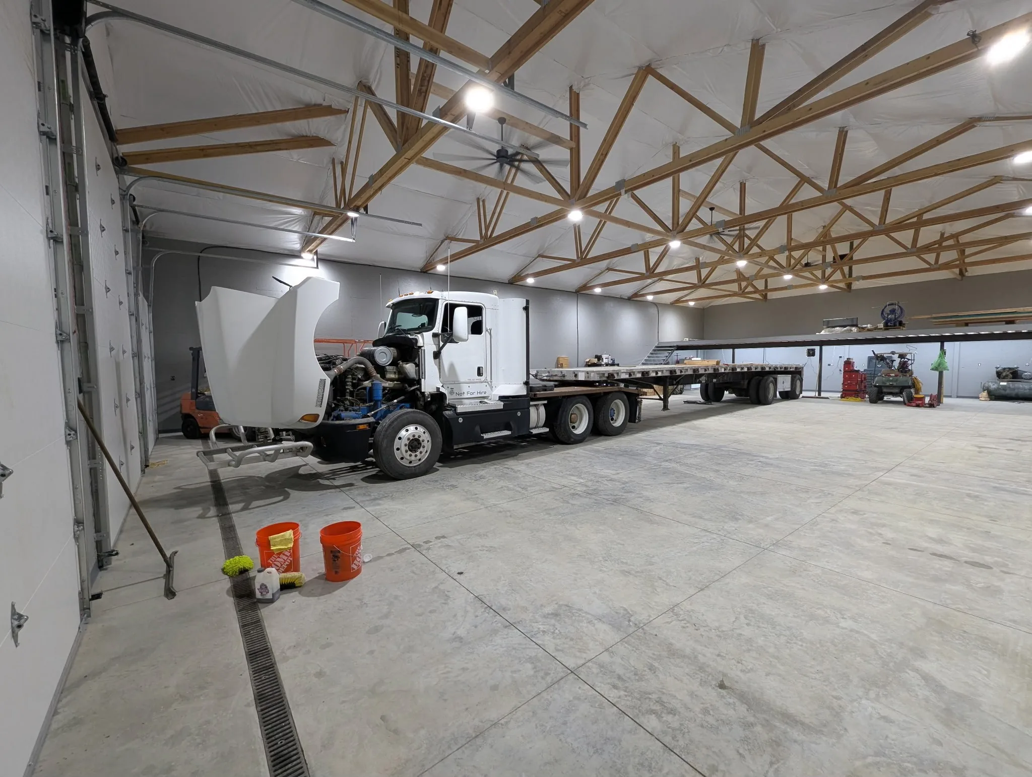 Semi-truck parked inside finished pole barn slab