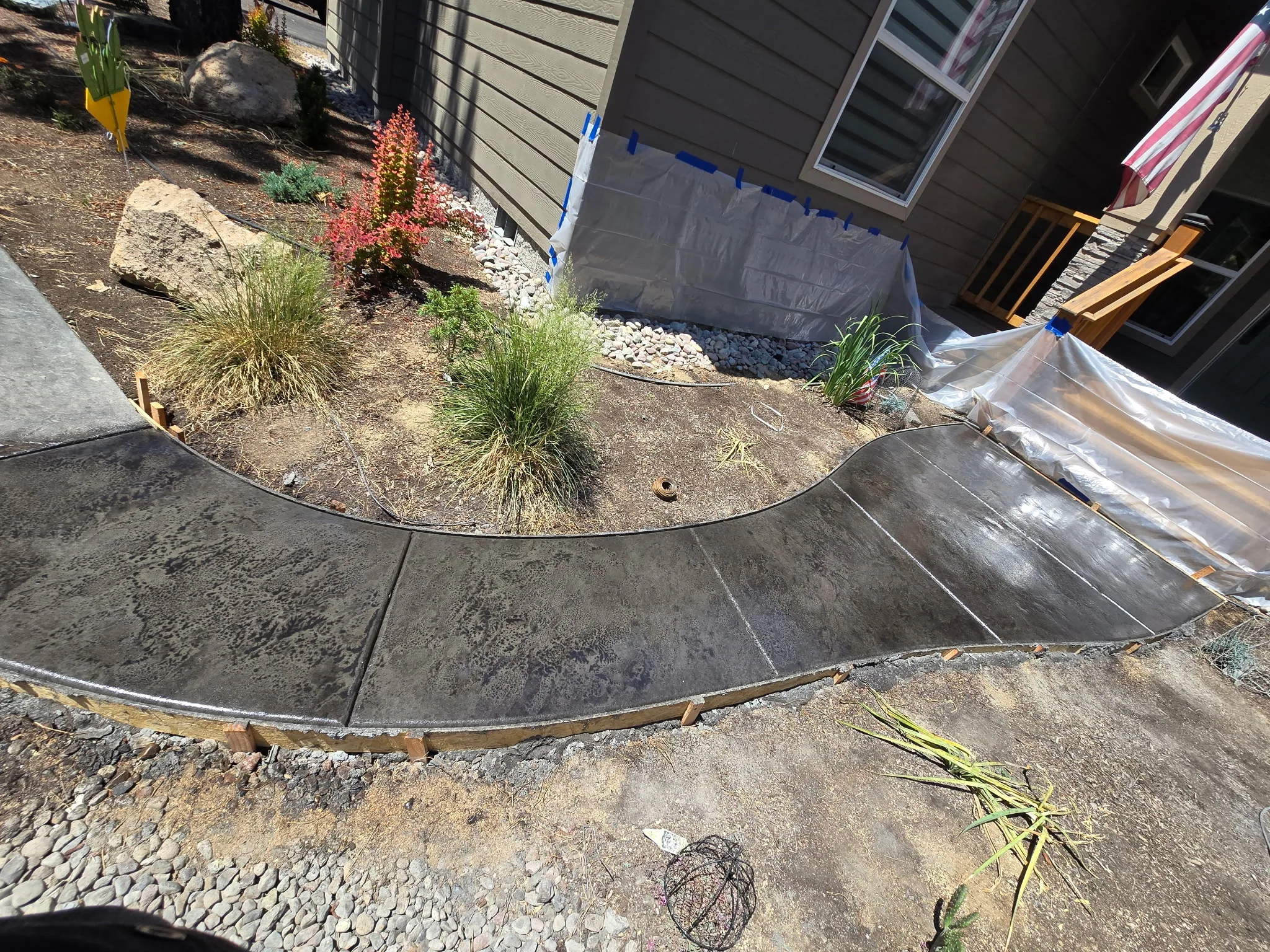 Curved garden walkway with charcoal slate stamp
